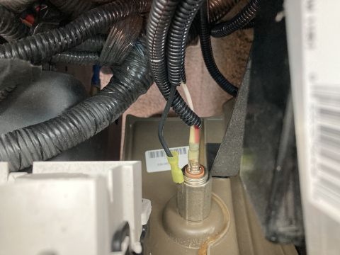 2015 Ford F-550 - A close-up view shows electrical wiring and connectors attached to a metal component, likely part of a vehicle's engine bay or undercarriag…