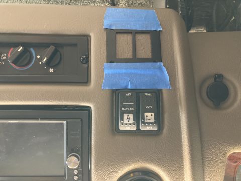 2015 Ford F-550 - A close-up view of a vehicle's dashboard showing climate controls, a car stereo, and two toggle switches labeled 'GENERATOR' and 'RADIO'. A…
