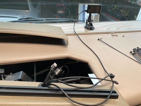 2015 Ford F-550 - A Garmin GPS device is mounted on the dashboard of a vehicle, with cables running down into an open compartment. A bundle of zip ties and s…