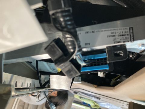 2015 Ford F-550 - Close-up view of a silver metal bracket with a label that reads "PULLMAN" and other text, attached to a vehicle's interior. Several black e…