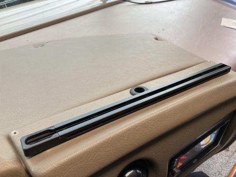 2015 Ford F-550 - A black RAM Tough-Track rail is mounted on a tan dashboard of a vehicle. The track appears to be a modification for mounting accessories.