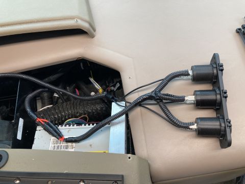 2015 Ford F-550 - A close-up view shows a custom wiring harness with three black connectors mounted on a black panel, connected to an electronic device with…