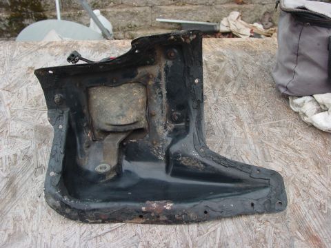 1973 Ford Ranchero - This is a black metal automotive part, showing signs of rust and wear.