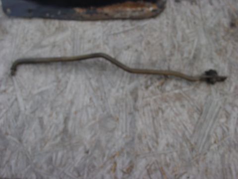 1973 Ford Ranchero - A single metal rod with a bracket is shown against a textured background.