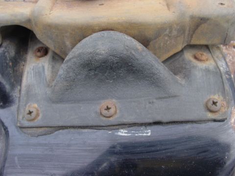 1973 Ford Ranchero - A close-up view of a black rubber component, showing signs of wear and rust around the screws.