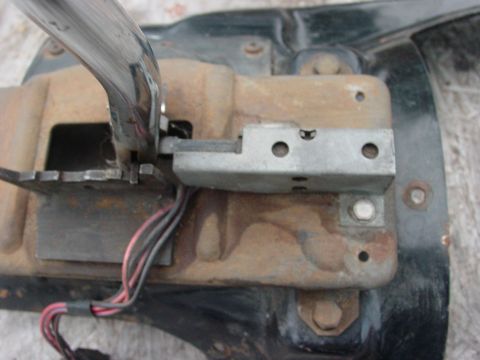 1973 Ford Ranchero - A close-up view of a chrome shifter lever mechanism with visible wiring and rusted metal components, likely from a vintage vehicle.