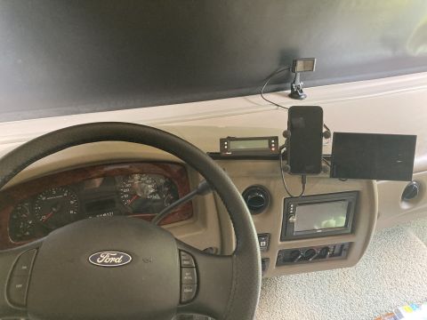 2015 Ford F-550 - The interior of a Ford F-550 RV is shown, focusing on the dashboard with a steering wheel, instrument cluster, and various mounted electron…
