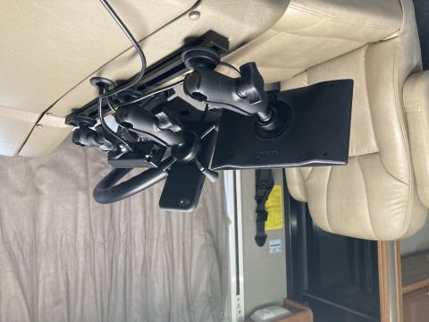 2015 Ford F-550 - A Garmin GPS unit and a smartphone are mounted on a multi-arm bracket system attached to the dashboard of an RV.