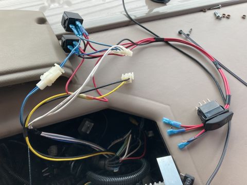2015 Ford F-550 - A close-up view of a vehicle's interior wiring harness, including relays, a switch, and various colored wires connected with crimp connecto…