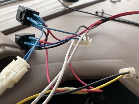 2015 Ford F-550 - A close-up view of automotive wiring harness connections, including two black relay sockets with blue wire connectors, and several other wi…