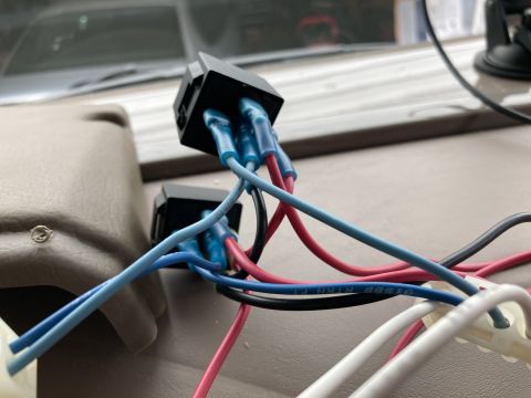 2015 Ford F-550 - Close-up view of electrical wiring connected to two black relay sockets, with blue, red, black, and white wires visible.