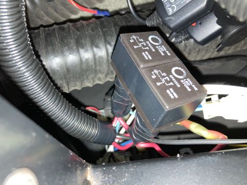 2015 Ford F-550 - Two automotive relays labeled "ONLINE LED STORE EPS131R 30/40A 12VDC" are visible, connected to a wiring harness protected by black corruga…