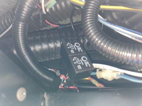 2015 Ford F-550 - A close-up view shows a black dual rocker switch panel with "ON" and "OFF" symbols, wired with multiple colored cables and protected by bla…