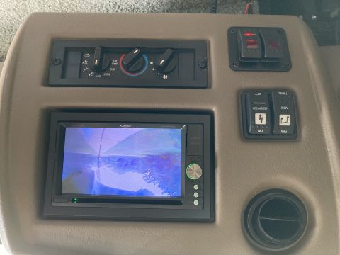 2015 Ford F-550 - The interior dashboard of a vehicle features a touchscreen display, climate controls, and various switches. A circular air vent is visible…