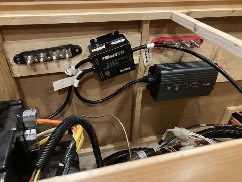 2015 Ford F-550 - Close-up view of electrical components, including an inverter and fuse block, installed within a wooden enclosure.