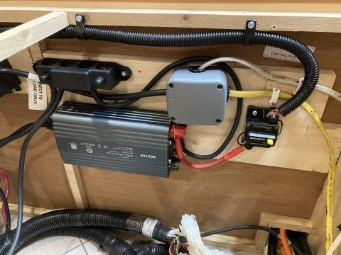 2015 Ford F-550 - This image shows a close-up view of electrical components installed in what appears to be a vehicle's interior or storage compartment. Visi…