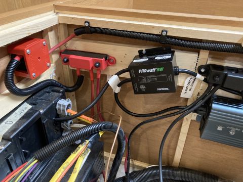 2015 Ford F-550 - A close-up view of electrical components, including red fuse holders, a black Xantrex PROwATT SW transfer switch, and wiring, installed wit…