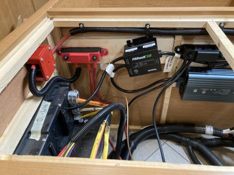 2015 Ford F-550 - This is an image of electrical components installed within a wooden enclosure. Visible components include red fuse holders, a black Xantrex…
