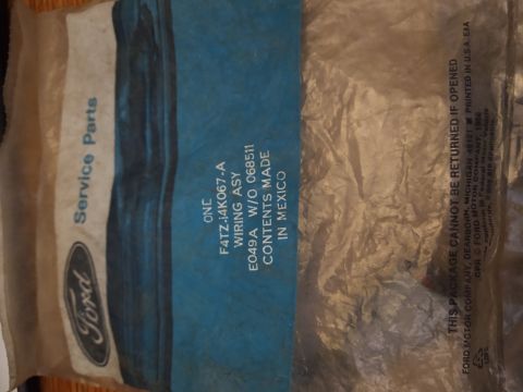 1996 Ford Bronco - A close-up of a Ford Service Parts bag containing a wiring assembly. The bag is made of plastic and has text indicating the part number and…