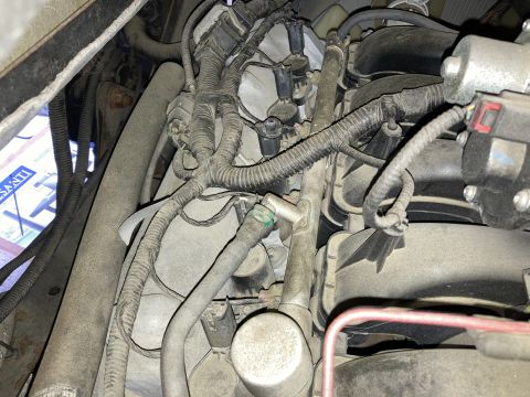 2015 Ford F-550 - A close-up view of the engine bay of a 2015 Ford F-550, showing a complex network of wiring harnesses, hoses, and engine components covered…