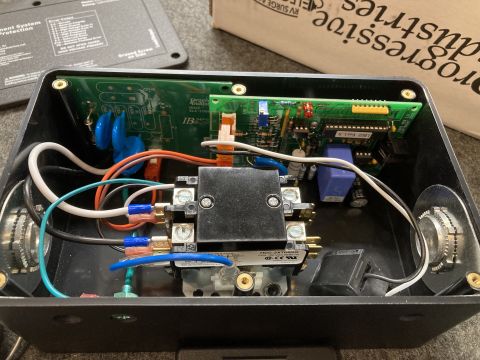 2015 Ford F-550 - Close-up view of the internal components and wiring of a Progressive EMS-HW30C surge protector.