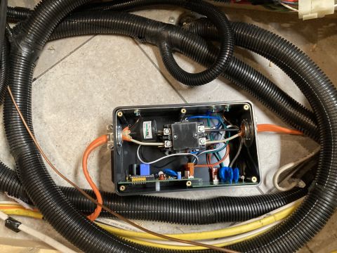 2015 Ford F-550 - An electrical surge protector is shown with various wires and black corrugated tubing.