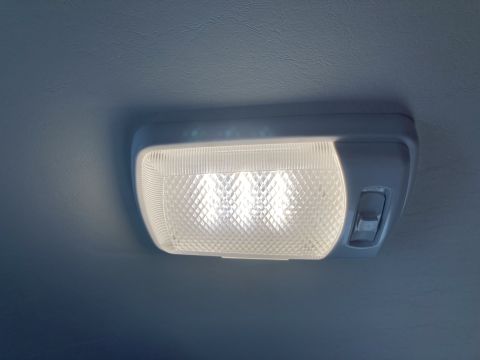 2015 Ford F-550 - Close-up of a vehicle's interior dome light with a textured lens and a toggle switch.