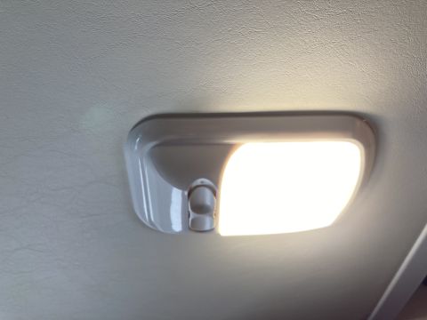 2015 Ford F-550 - Close-up of an interior dome light with two buttons, illuminated.