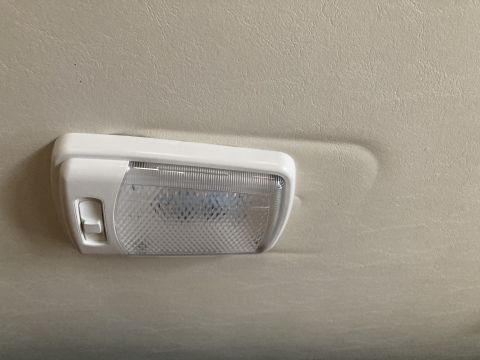 2015 Ford F-550 - A close-up of a white interior dome light fixture mounted on a textured ceiling panel.
