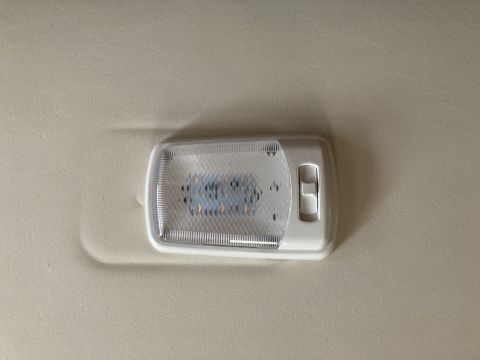 2015 Ford F-550 - Interior light assembly with a clear lens and white housing, mounted on a textured headliner.