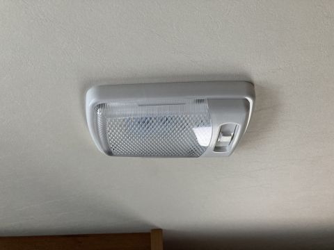 2015 Ford F-550 - Close-up of an interior dome light fixture with a textured lens and side switch.