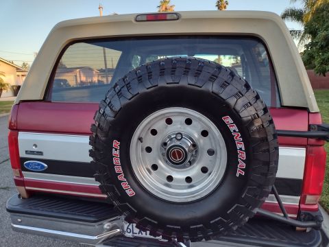 1994 Ford Bronco - The rear of a 1994 Ford Bronco is shown, a spare tire and a two-tone paint scheme.
