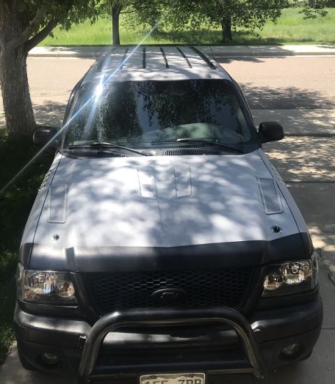 2000 Ford Explorer - This 2000 Ford Explorer is parked in a driveway with trees overhead.