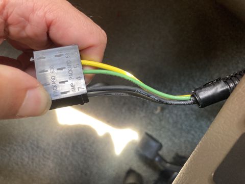 2015 Ford F-550 - Close-up of a Packard 630 electrical connector with yellow and green wires, likely part of a vehicle's wiring harness.