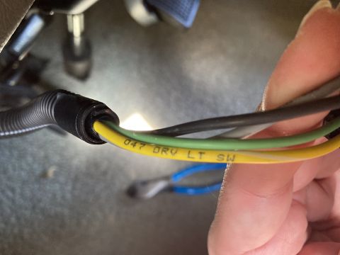 2015 Ford F-550 - Close-up of a vehicle's wiring harness, showing a yellow wire with printed markings.
