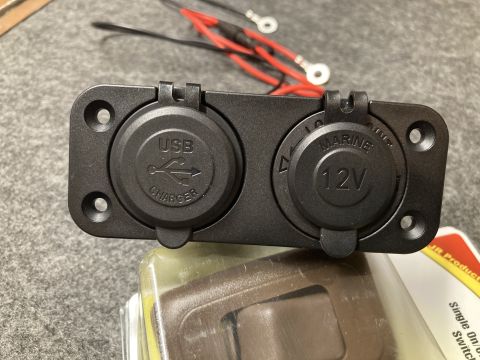 2015 Ford F-550 - Close-up of a dual USB and 12V marine power outlet with attached wiring.
