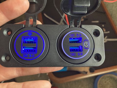 2015 Ford F-550 - Close-up of a dual USB charger with blue illuminated QC 3.0 ports.