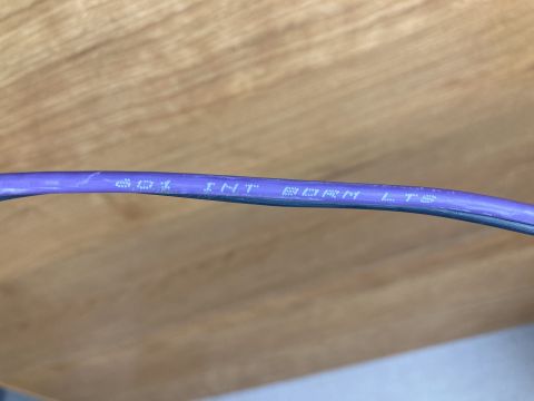 2015 Ford F-550 - Close-up of a purple wire with embossed text that reads 'INT BORN LTS'.