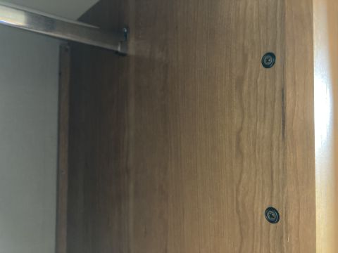 2015 Ford F-550 - Close-up of an interior cabinet panel with visible screws and a metal rail.