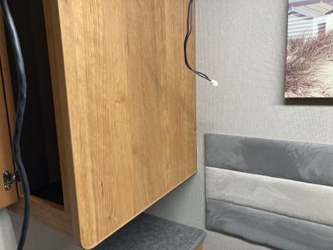 2015 Ford F-550 - Interior view of a cabinet and headboard, with a picture on the wall and visible wiring.