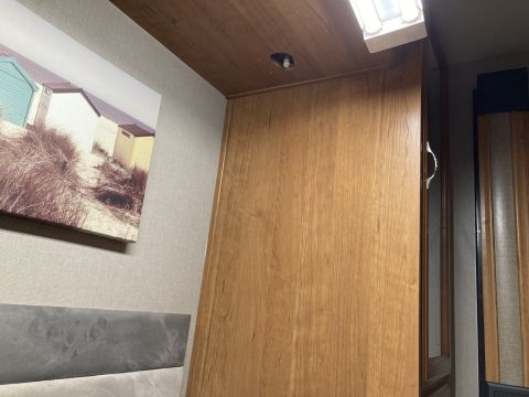 2015 Ford F-550 - Interior view of a room with wood paneling and a framed picture of beach huts on the wall.