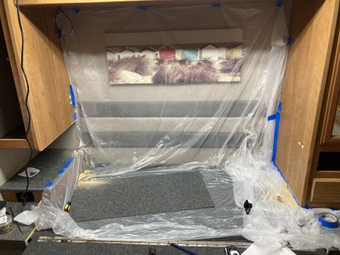 2015 Ford F-550 - Plastic sheeting covers the bed area of an RV, with a beach scene painting on the wall.