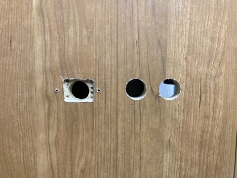 2015 Ford F-550 - Wood paneling shows three openings: one square and two round.