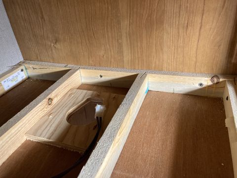 2015 Ford F-550 - Close-up view of the unfinished wooden interior construction and wiring within a compartment.