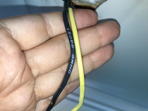 2015 Ford F-550 - Close-up of a hand holding electrical wires, one labeled 'GRND'.