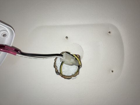 2015 Ford F-550 - Close-up of exposed wiring and connector in a vehicle's interior ceiling panel.