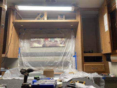 2015 Ford F-550 - RV interior undergoing renovation, showing covered furniture and tools.