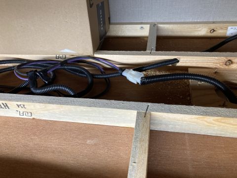 2015 Ford F-550 - Close-up view of electrical wiring and wooden structural components within a confined space.