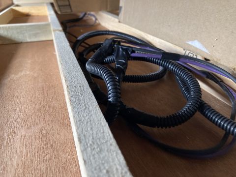2015 Ford F-550 - A close-up view of a wiring harness with black tubing and purple wires.
