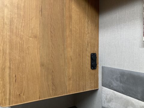 2015 Ford F-550 - Interior view of a cabinet with two light switches, part of a recreational vehicle.